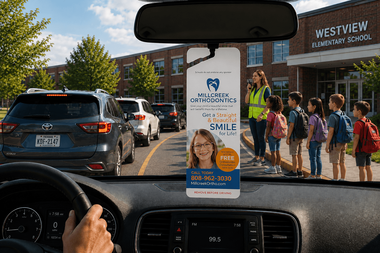 A Parent Pick-Up Tag hanging from a car mirror during school dismissal