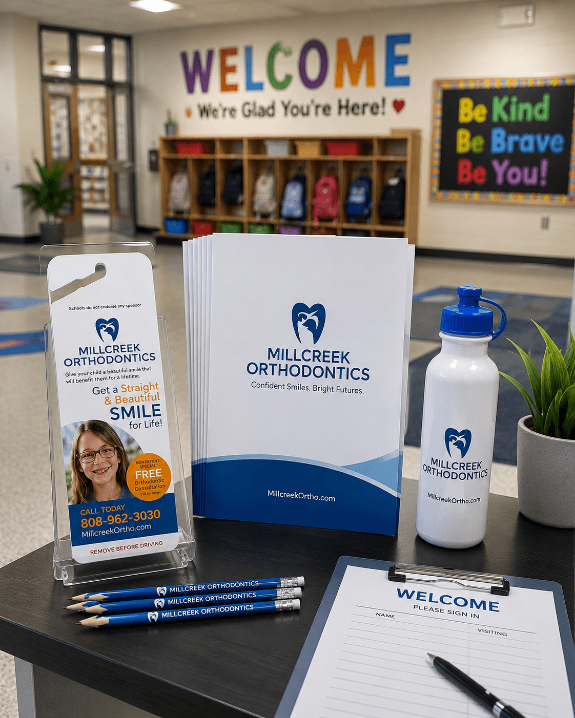 A welcoming elementary school hallway with student backpacks and a sign-in table